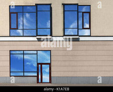 Glass door and windows with sky reflections of new no name office in the modern mass production  building. Collage from several summer  photos.  Glass Stock Photo