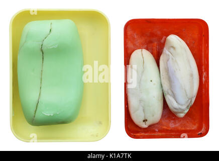 Old rustic dry cracked soap in plastic broken dishes. Isolated with patch Stock Photo
