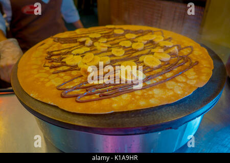 Making banana chocolate Pancake on an electric cooker Stock Photo
