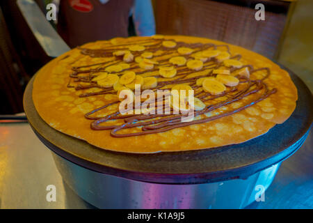 Making banana chocolate Pancake on an electric cooker Stock Photo
