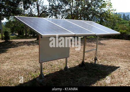 solar energy panels installed on the lawn for generating clean power Stock Photo