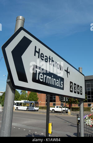 left pointing road sign for heathrow airport terminals 2 3 4 and 5 Stock Photo