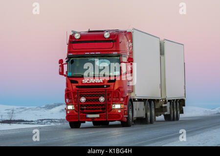 Scania truck driving on winter road in Finnmark Stock Photo