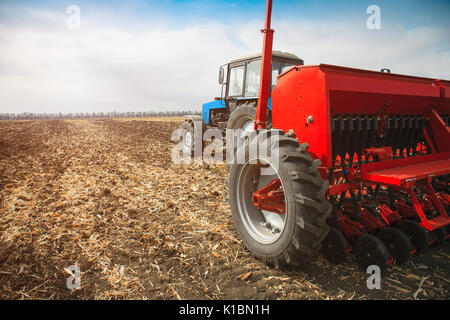 Modern tractor in the field with complex for the plowing of soil. The ...