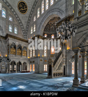 Interior shot of Nuruosmaniye Mosque, an Ottoman Baroque style mosque with minbar (platform), huge arches & colored stained glass windows located in S Stock Photo