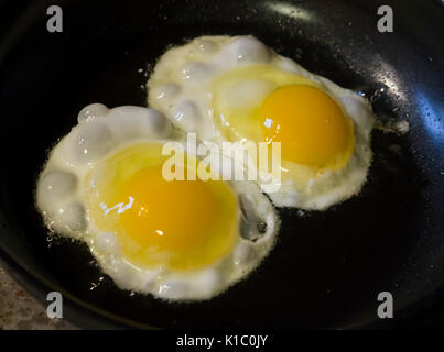 Two eggs frying Stock Photo