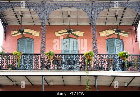 French Quarter building with iron balcony and ceiling fans.  New Orleans, LA. Stock Photo