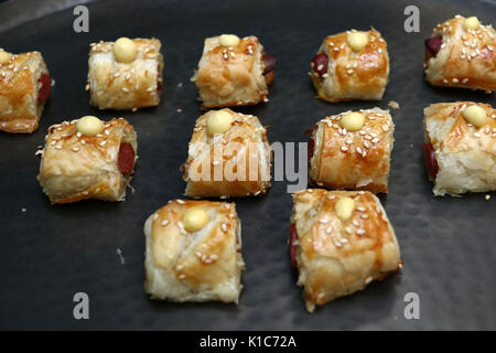 Pigs in a blanket hors d'oeuvres with mustard droplet Stock Photo