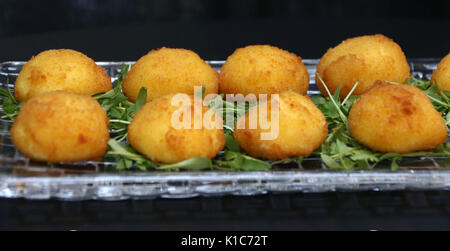 Fried cheese balls filled with mozzarella cheese hors d'oeuvres on crystal dish Stock Photo