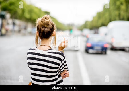 Woman smoking on the street Stock Photo