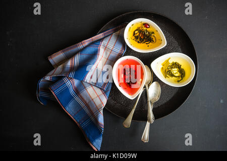 Different types of tea, green tea, peony and ginger tea, rose bud and wild flowers tea on dark wooden background with copyspace Stock Photo