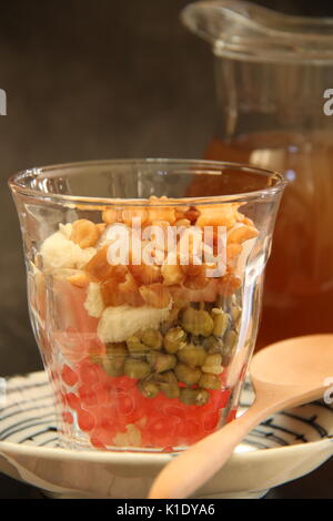 Sekoteng Betawi. Warm Ginger Drink with Tapioca Pearls, Mung Beans, Bread Cubes, Palm Fruit and Peanuts Stock Photo