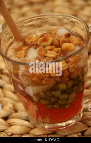 Sekoteng Betawi. Warm Ginger Drink with Tapioca Pearls, Mung Beans, Bread Cubes, Palm Fruit and Peanuts Stock Photo