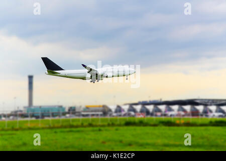 white airplane landing at the airport Stock Photo