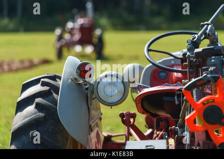 DUNDAS, PRINCE EDWARD ISLAND, CANADA - 25 Aug: Competitors plow with amtique tractors at the PEI Plowing Match and Agricultural fair on August 25, 201 Stock Photo