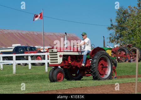 DUNDAS, PRINCE EDWARD ISLAND, CANADA - 25 Aug: Competitors plow with amtique tractors at the PEI Plowing Match and Agricultural fair on August 25, 201 Stock Photo