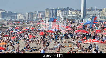 Brighton, UK. 27th Aug, 2017. Crowds enjoy the beautiful hot sunny weather on Brighton beach today as temperatures are expected to reach as high as 28 degrees over the bank weekend which is a record for August Credit: Simon Dack/Alamy Live News Stock Photo