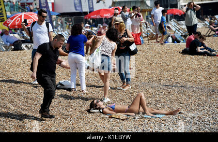 Brighton, UK. 27th Aug, 2017. Crowds enjoy the beautiful hot sunny weather on Brighton beach today as temperatures are expected to reach as high as 28 degrees over the bank weekend which is a record for August Credit: Simon Dack/Alamy Live News Stock Photo