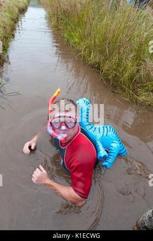 Llanwrtyd Wells, Powys, UK. 27th August, 2017. The 32nd annual World Bog Snorkelling Championships, conceived over 30 years ago in a Welsh pub by landlord Gordon Green, are held at the Waen Rhydd Bog. Using unconventional swimming strokes, participants swim two lengths of a 55 metre trench cut through a peat bog wearing snorkel mask and flippers. Credit:  Graham M. Lawrence/Alamy Live News Stock Photo