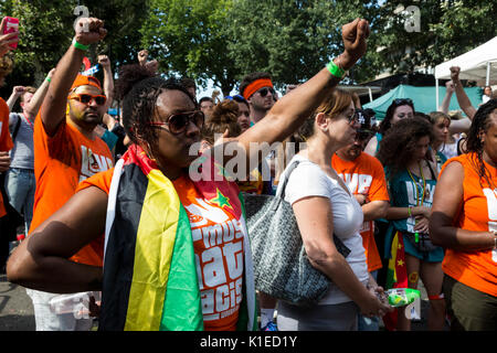 London, UK. 27th Aug, 2017. Carnival-goers observe a 3-minute silence to honour the victims of the Grenfell Tower fire. Credit: Bettina Strenske/Alamy Live News Stock Photo
