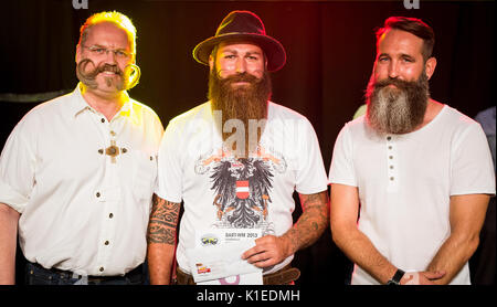 Stuttgart, Germany. 27th Aug, 2017. The three best placed participants of the Swabian Beard Championships for everyone stand together for a group picture during the brewery festival of the brewery 'Stuttgarter Hofbräu' in Stuttgart, Germany, 27 August 2017. Marc Bereiter (C) won the competition, second placed Enrico Todt (R) and third placed Thomas Klingenberg (L). Photo: Christoph Schmidt/dpa/Alamy Live News Stock Photo