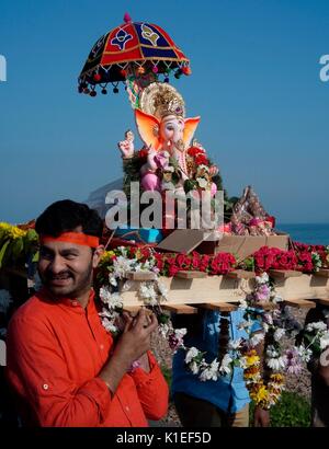 Worthing, UK. 27th Aug, 2017. Celebrating Ganesh Festival in the U.K. - Members of the local Hindu community carry a model of Lord Ganesh along the beach front to the English Channel. Also known as Ganesh Chaturthi, the important festival celebrates the elephant-headed son of Lord shiva and Goddess Parvati, a symbol of wisdom, prosperity and good fortune. The model is made of plaster of paris and dissolves in sea-water. Credit: Photo: Jonathan Eastland/Ajax/Alamy Live News Stock Photo