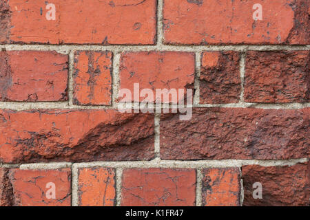 Cracked grungy red brick wall fragment background texture closeup Stock Photo