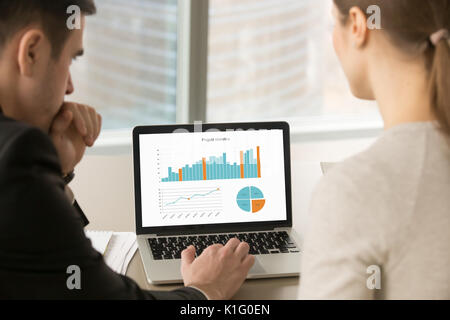 Business team analyzing stats data on laptop screen, project man Stock Photo
