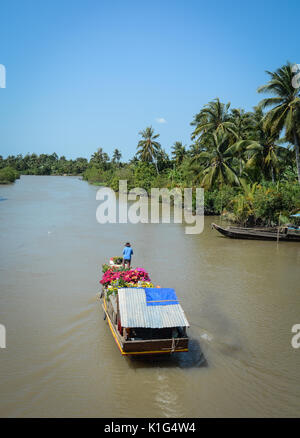 Wooden boat on river in Mekong Delta, Southern Vietnam. The Mekong is a trans-boundary river in Southeast Asia. Stock Photo