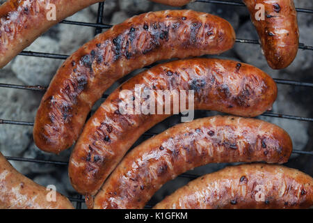 Traditional Polish sausages being prepared on a barbecue. Stock Photo