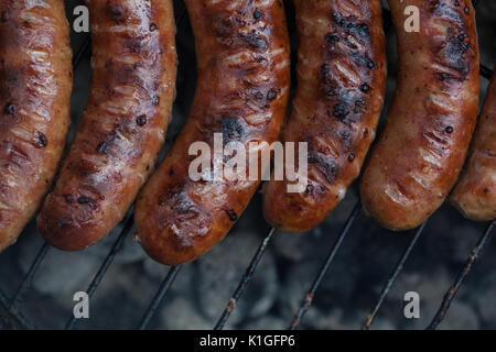 Traditional Polish sausages being prepared on a barbecue. Stock Photo