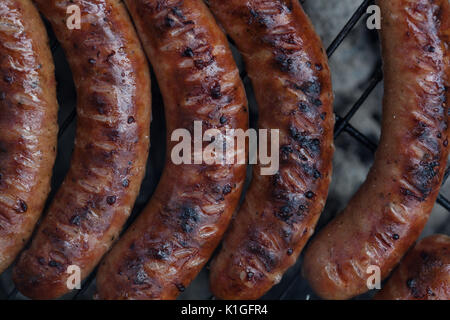 Traditional Polish sausages being prepared on a barbecue. Stock Photo