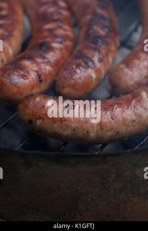 Traditional Polish sausages being prepared on a barbecue. Stock Photo