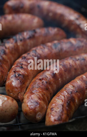 Traditional Polish sausages being prepared on a barbecue. Stock Photo