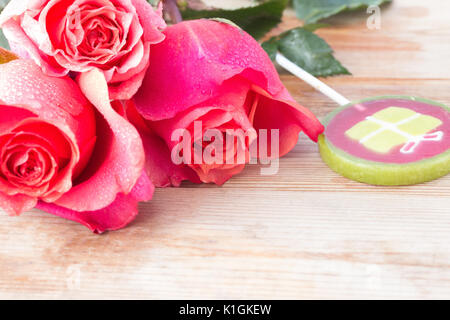 pink roses and sweets on table. copy space Stock Photo
