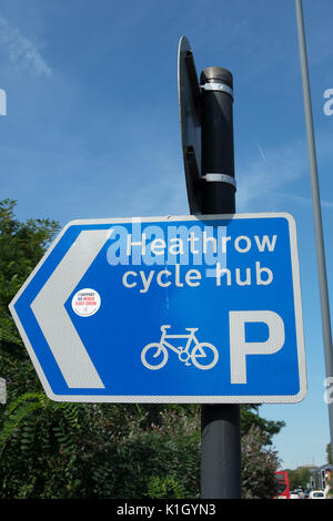 left pointing sign given directions to the heathrow cycle hub, near heathrow airport, west london, england, with sticker from the union, unite Stock Photo