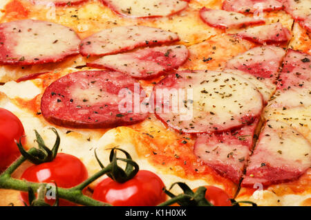 Tasty salami pizza with cherries ingredient close-up Stock Photo