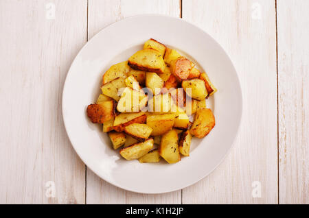 Roasted  baked potato in plate on wooden table Stock Photo
