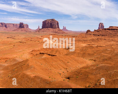 A dirt road is winding through Butte rock formations at Monument Valley Navajo Tribal Park, USA. Stock Photo