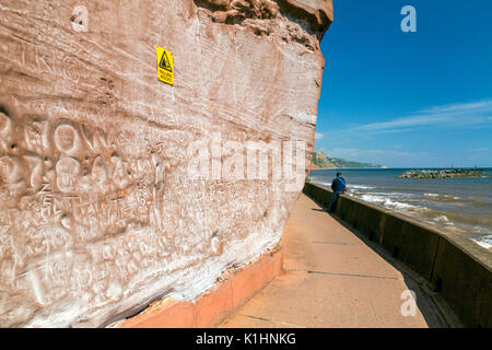The names of countless visitors from previous years have been scratched into the sandstone cliffs at Sidmouth on the Jurassic Coast, Devon, England, U Stock Photo