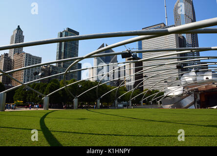 The lawn at the Jay Pritzker Pavilion in Millennium Park, with Chicago's downtown skyline looming above, is a popular spot for music. Stock Photo