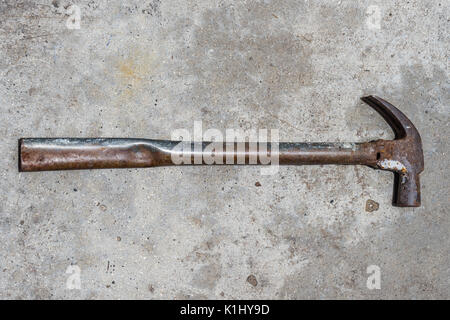 Old tools Iron Hammer on ages cement floor, Old Metal Hammer in vintage background Stock Photo