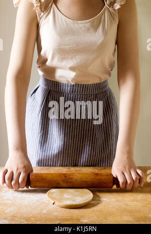 Woman rolling dough for gingerbread, rustic style, selective focus Stock Photo