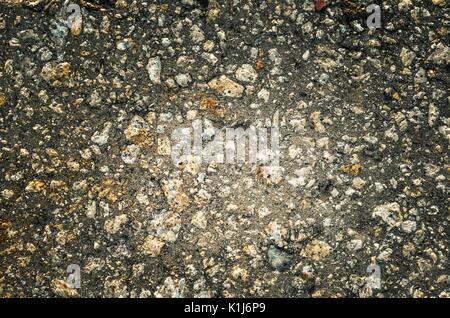 Dark stone background. Texture of pebbles with vignette. Stock Photo