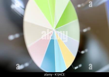 Analyzing stock market from a digital computer screen over a detailed diagram. Stock Photo