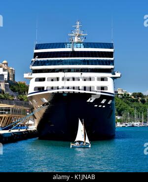 Azamara Journey R-class cruise ship with a small saling boat in Mahon Menorca Minorca Spain Stock Photo