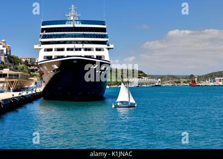 Azamara Journey R-class cruise ship with a small saling boat in Mahon Menorca Minorca Spain Stock Photo