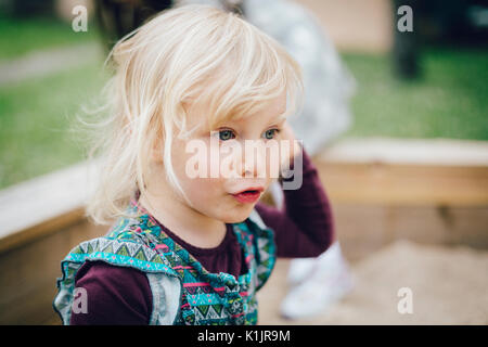 Little blond girl with tears on her cheeks. Stock Photo
