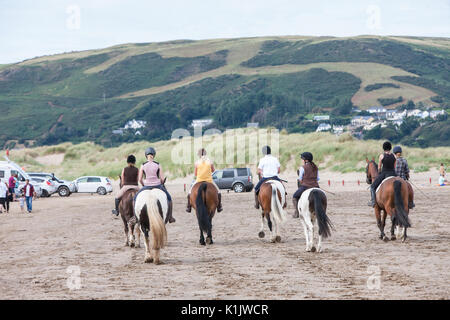 Riding,horses,horse,ponies,being,ridden,on,beach,at,Ynyslas,near,Borth,north,of,Aberystwyth,Ceredigion,Mid Wales,Wales,Welsh,U.K.,UK,GB,Europe, Stock Photo
