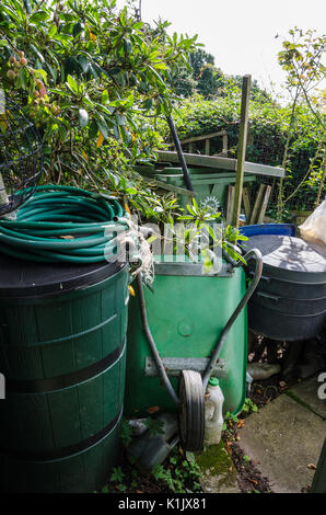 Clutter hidden away in a secluded corner of a garden. Stock Photo